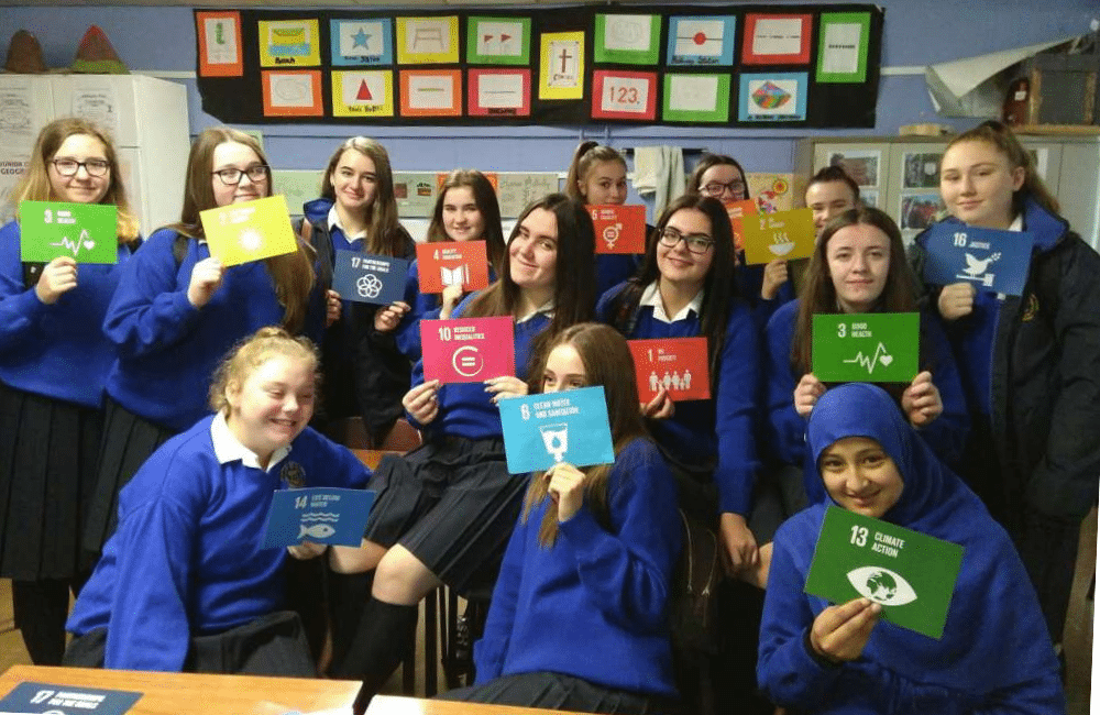 Class of girls holding SDG cards