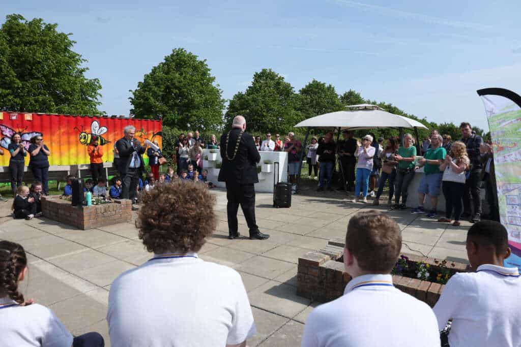 Mayor Mahony, seen from the back, addressing a crowd of people