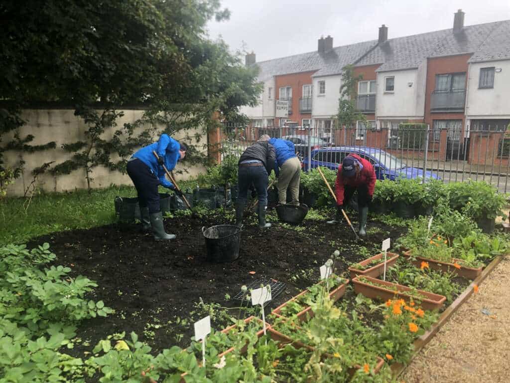 people working in the GLAS community garden