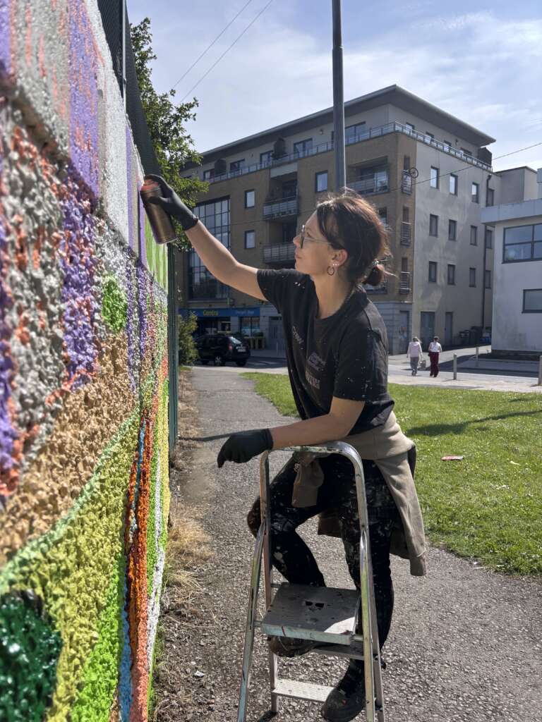 Magda Karol working on the mural