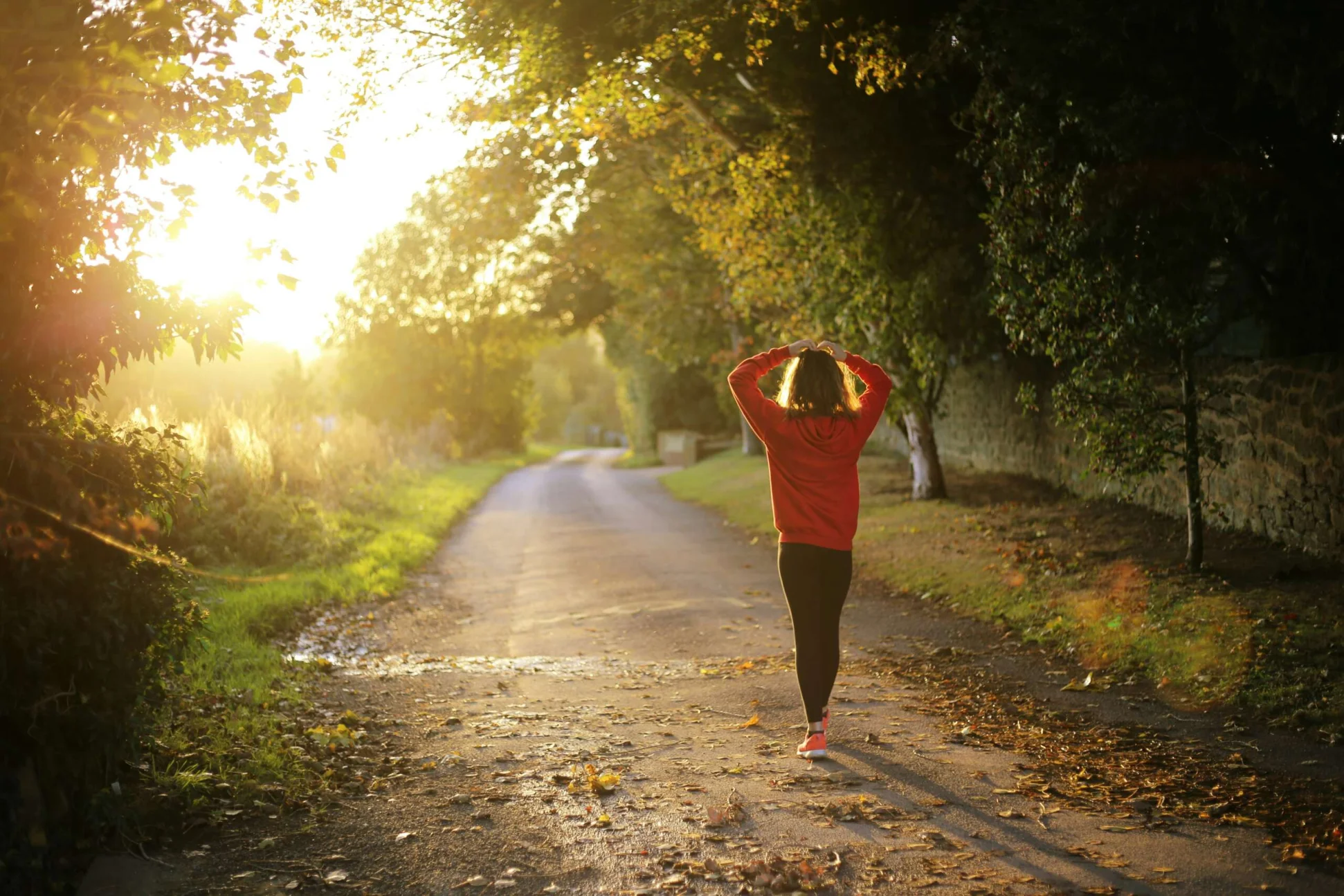 Woman on a morning walk in the country side. Photo by Emma Simpson - Unsplash